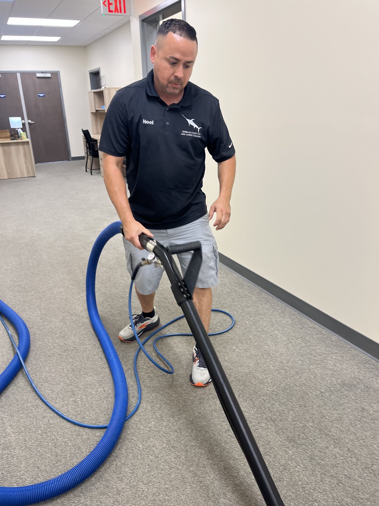Technician deep cleaning residential carpet in an Emerald Coast home