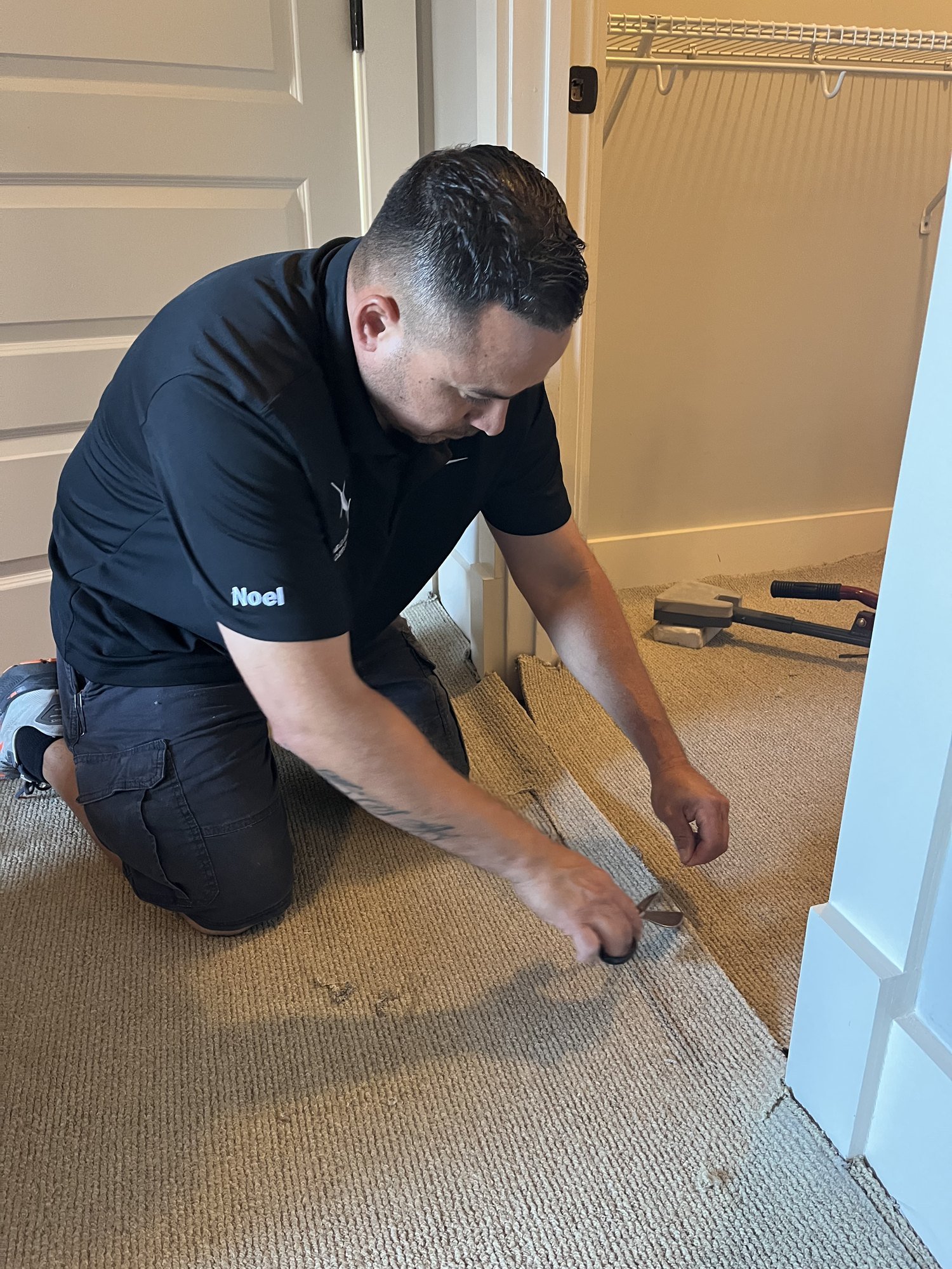 Technician carefully completing a localized carpet patch and repair