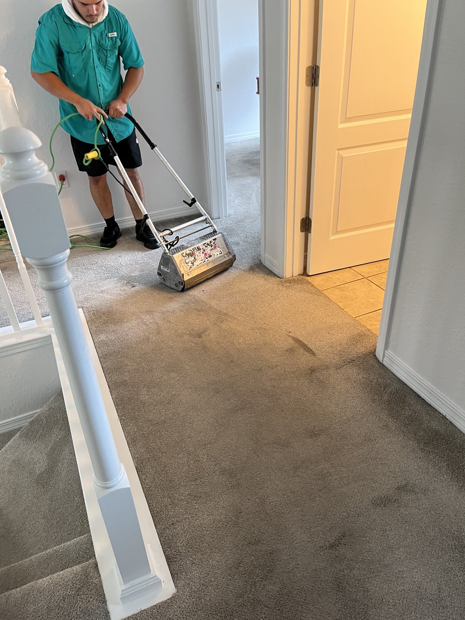 Emerald Coast technician treating heavily soiled carpet in a Santa Rosa Beach home