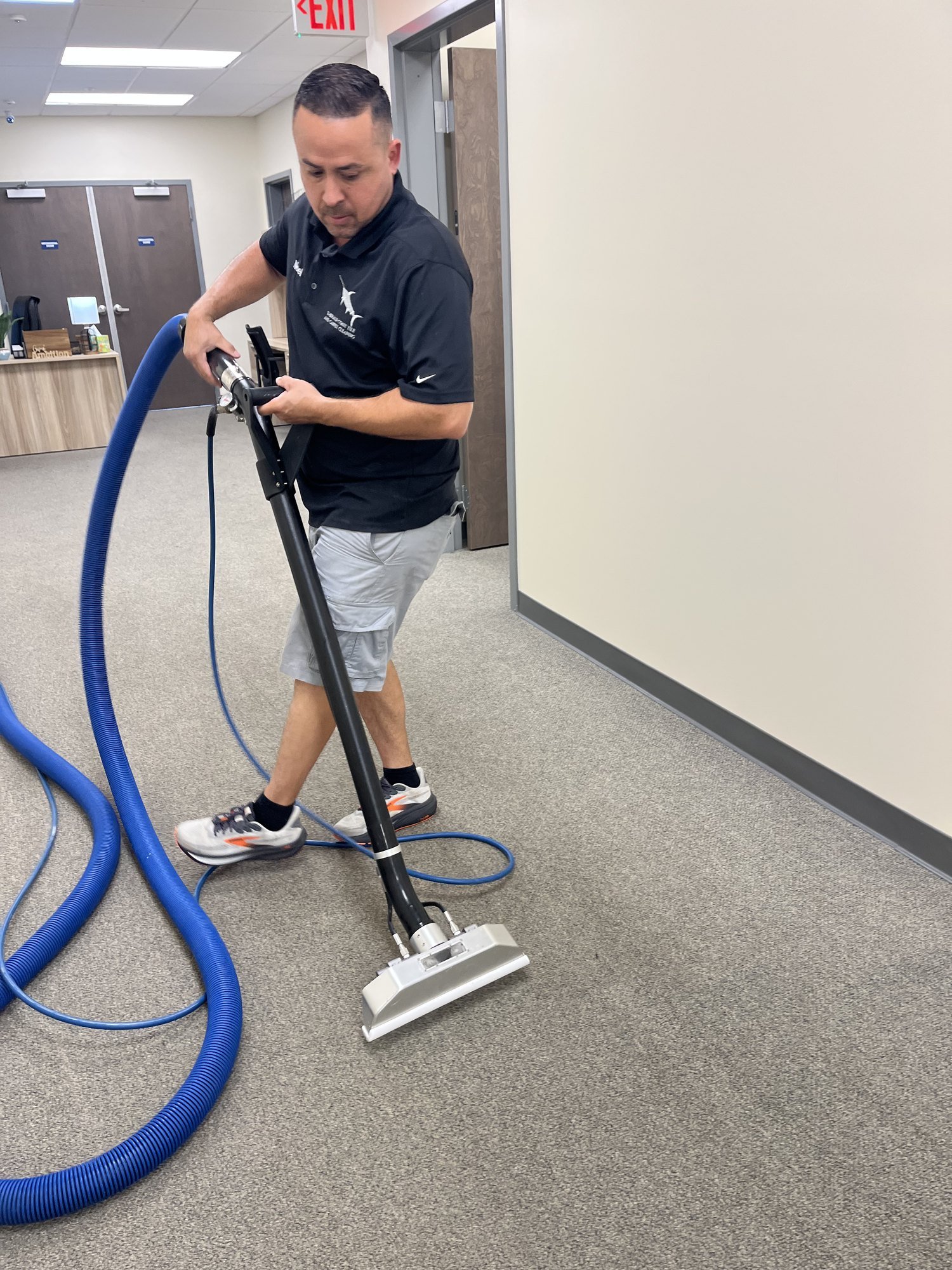 Professional extraction equipment cleaning residential carpet after targeted pet treatment