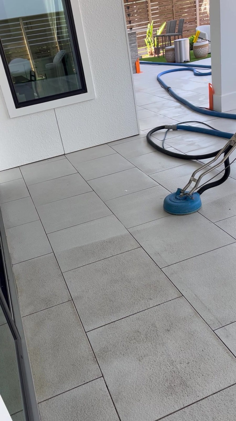 Technician cleaning tile and grout with professional equipment