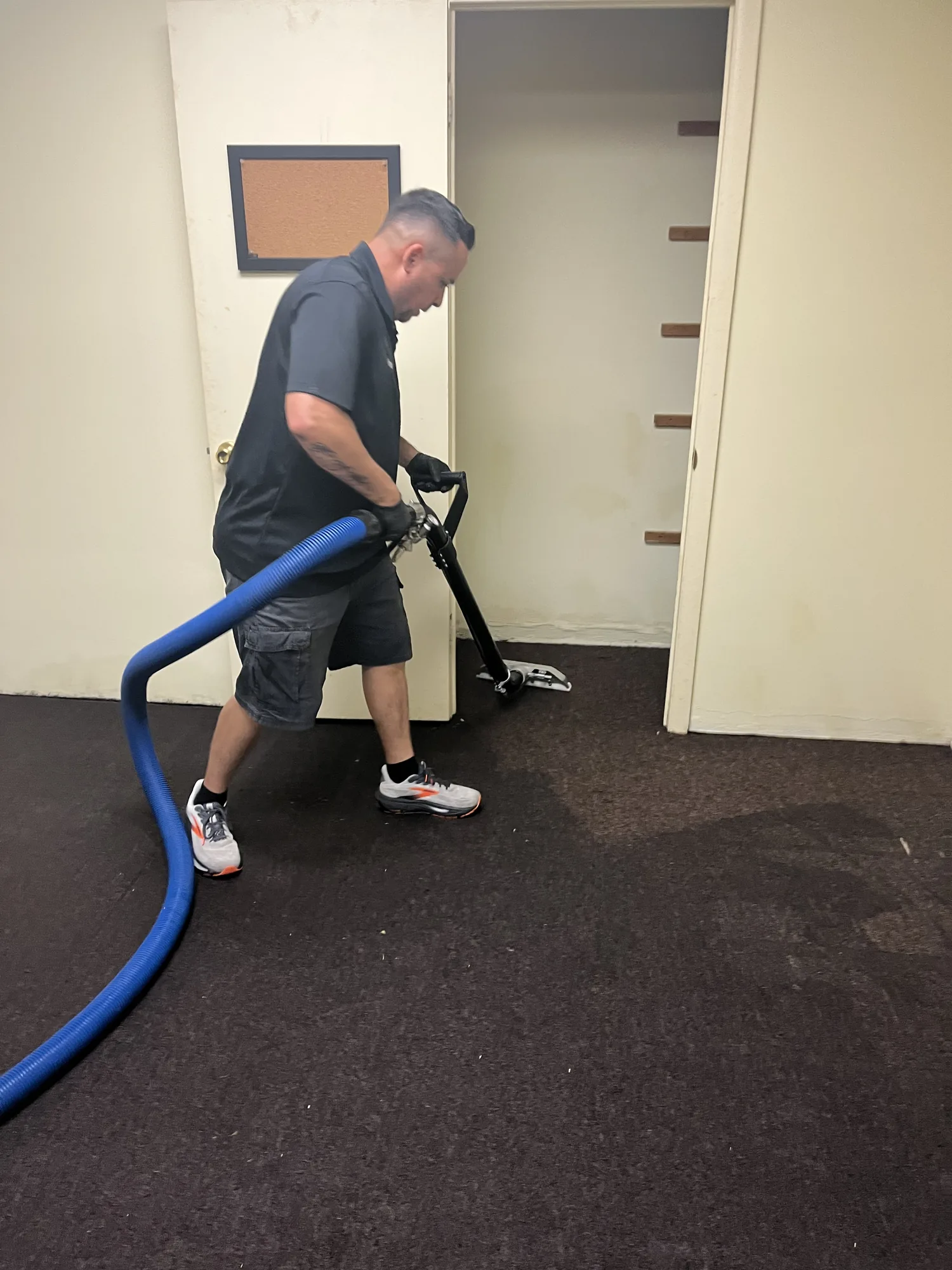 Technician extracting water from carpet.